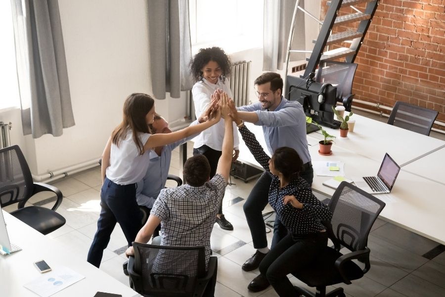 The Tech Punks' understanding of work Team high five in office